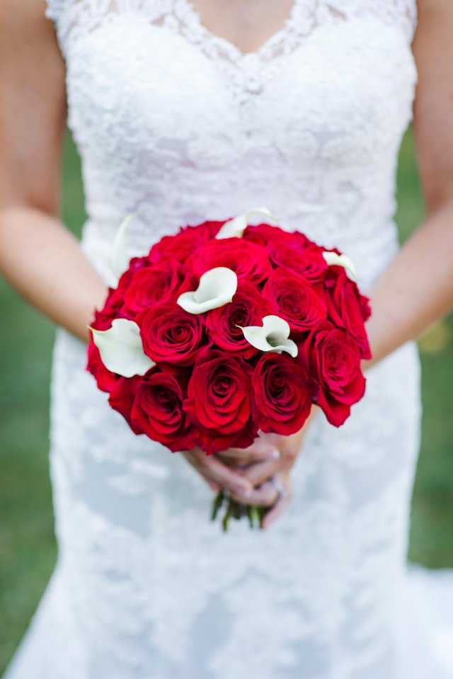 The bride's bouquet contained red roses and white calla lillies.