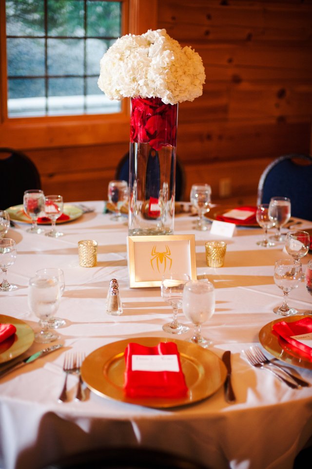 The superhero-titled tables with white hydrangeas and red roses.